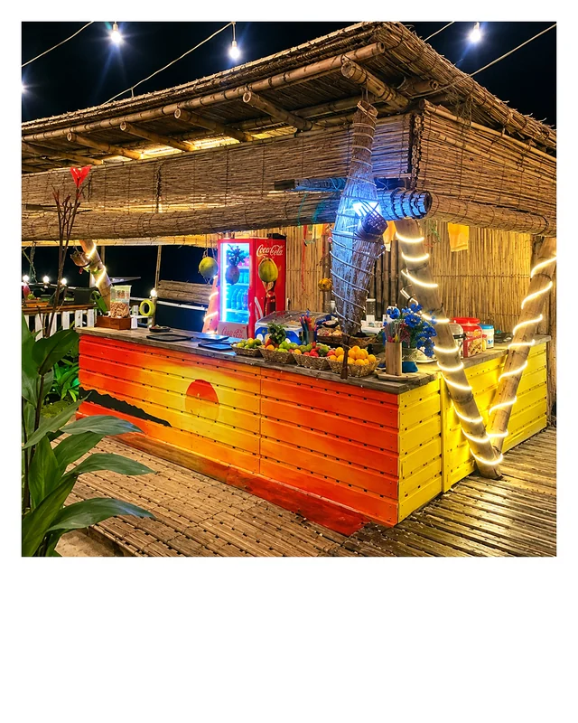 The café's colourful bamboo juice bar lit up at night