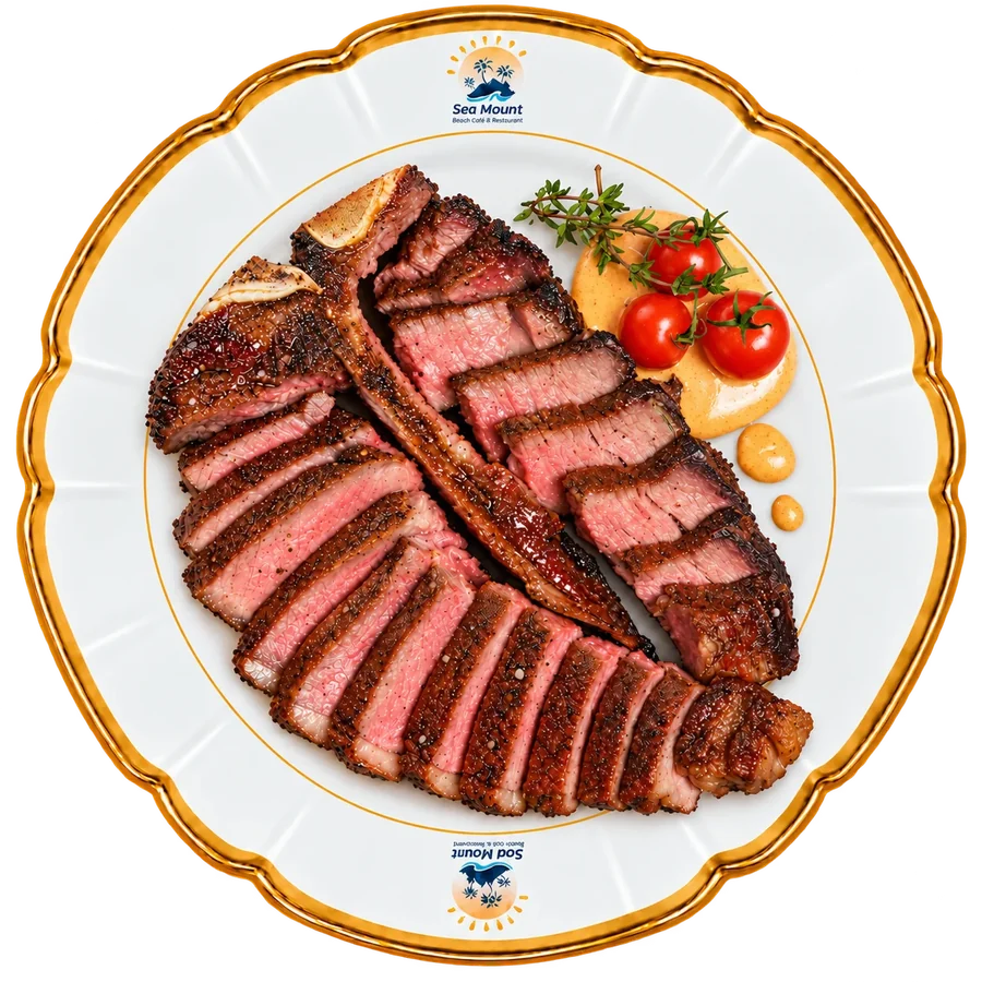 Sliced steak with tomatoes and sauce on a Sea Mount plate